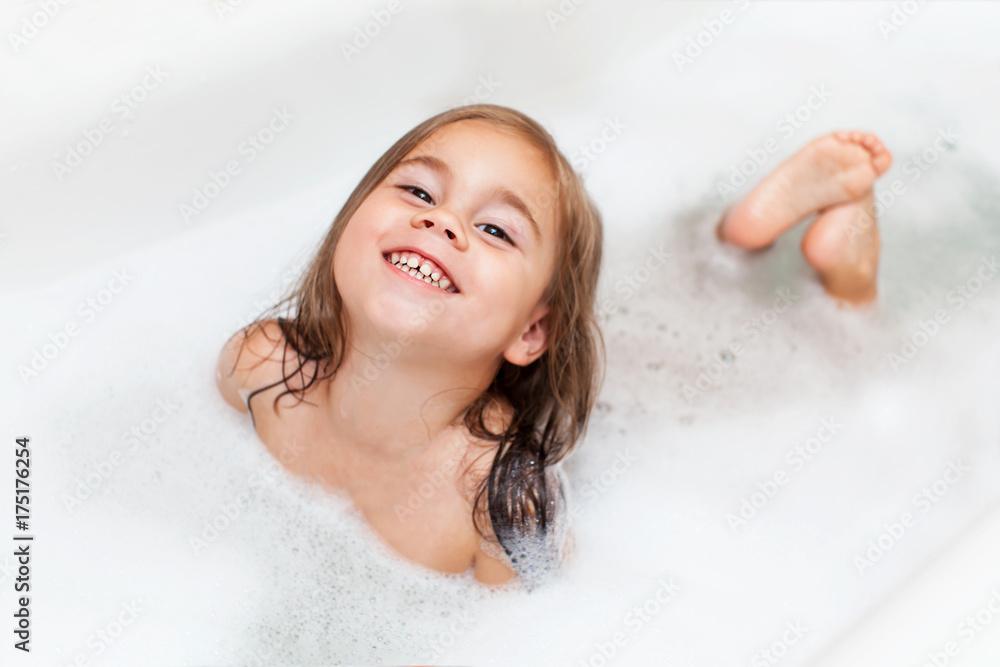 Happy little child girl is taking a bath with a foam Stock Photo ...