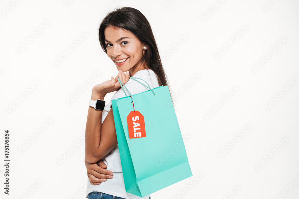 Portrait of a smiling young woman holding shopping bag Portrait of a smiling young woman holding shopping bag