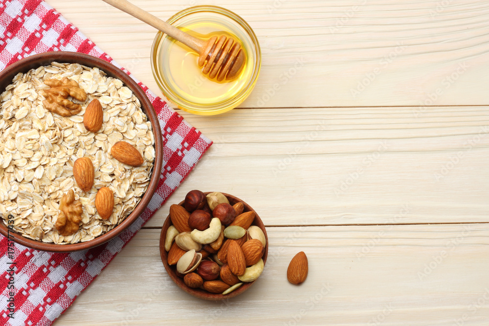 healthy breakfast. oatmeal, honey and nuts on white wooden table. Top view with copy space