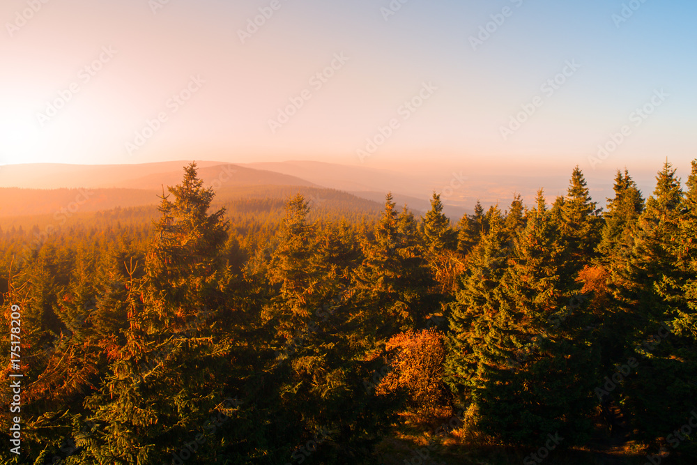 Autumn haze illuminated by sun above mountain peaks, Eagle Mountains, Orlicke hory, Czech Republic.