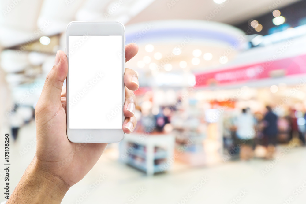 isolated man hand holding smart phone over abstract blurred background with bokeh in shopping mall, department store isolated man hand holding smart phone over abstract blurred background with bokeh in shopping mall, department store
