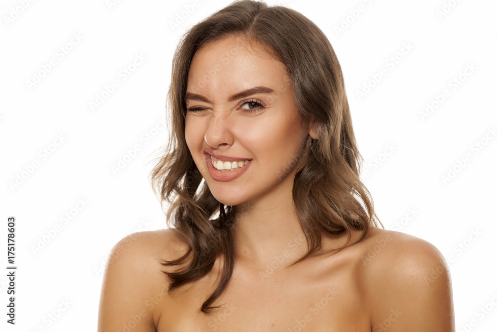 Portrait of beautiful silly woman winking on white background Portrait of beautiful silly woman winking on white background