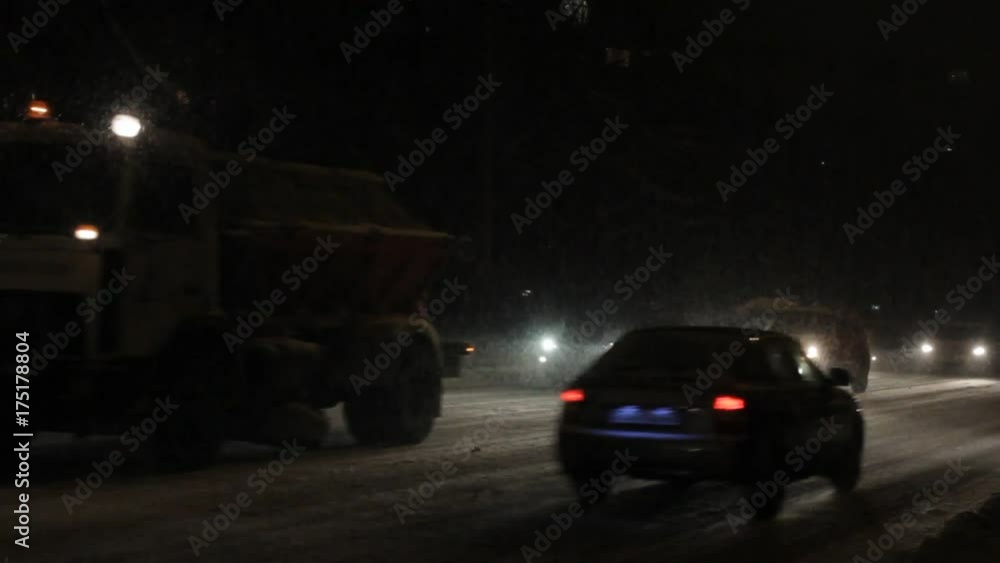 movement of city transport in the evening during snowfall movement of city transport in the evening during snowfall