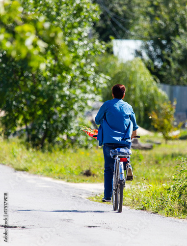 woman on a bicycle in the village