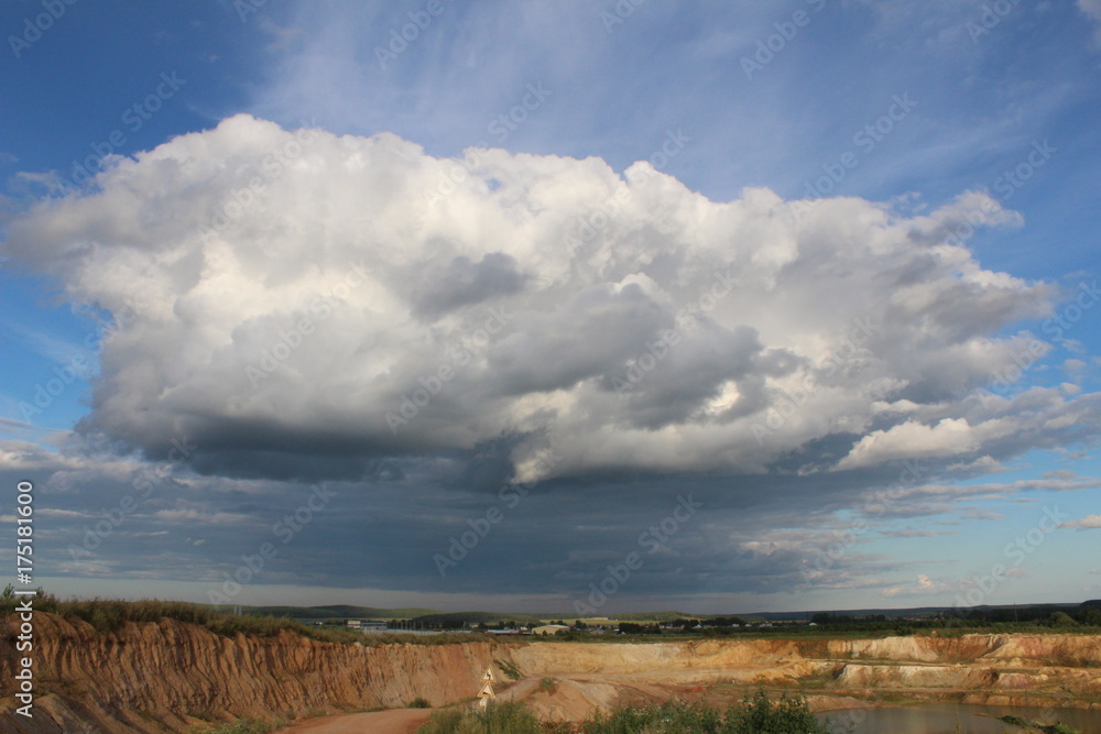 big cloud in the blue sky above the quarry