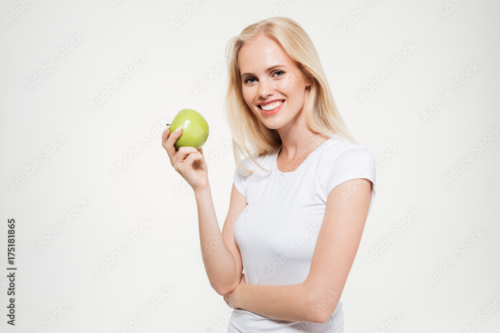 Portrait of a happy fit woman holding green apple Portrait of a happy fit woman holding green apple