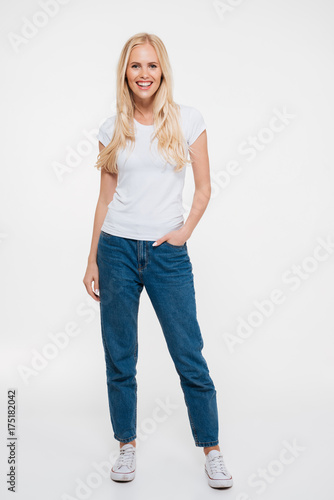 Full length portrait of a smiling casual woman standing