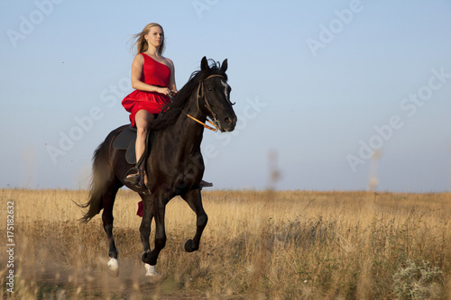 Young woman galloping on horseback