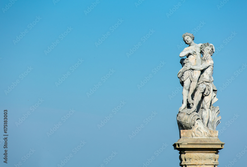 Classic statue in a park with blue sky on background