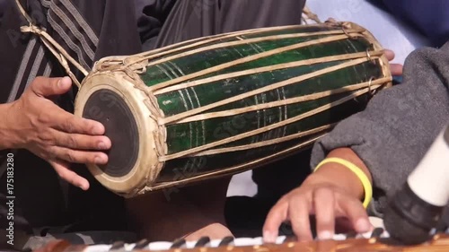 A man playing traditional drums - dhol photo