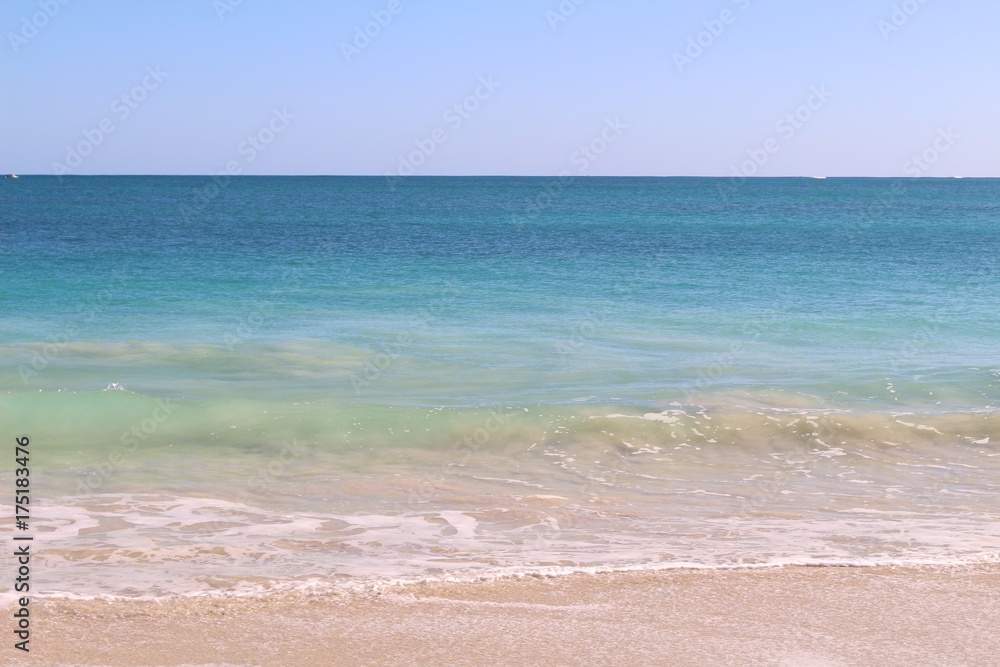 Beach background with white sand, turquoise water and blue sky near Perth, Western Australia