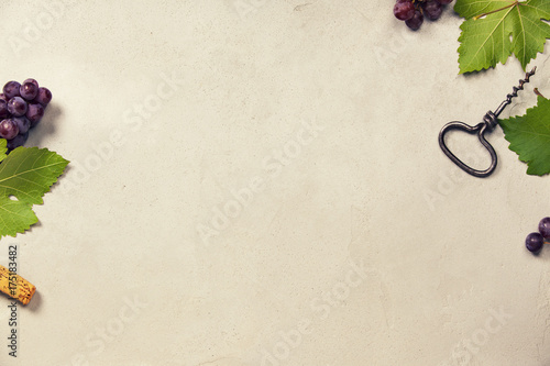 Wine and grapes over grey concrete background