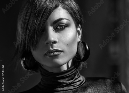 Fashion art portrait of elegant girl in geometric. Black and white photo of stylish young woman in cityscape . Stunning girl .