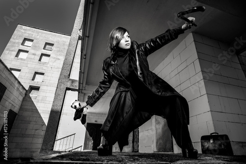 Fashion art portrait of elegant girl in geometric. Black and white photo of stylish young woman in cityscape