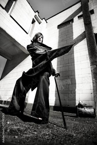 Fashion art portrait of elegant girl in geometric. Black and white photo of stylish young woman in cityscape