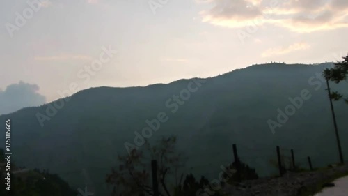 On The Road Near Mountain Landscape During Sunset - Pan - Right To Left  photo