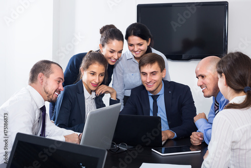 Workers talking about business project in office