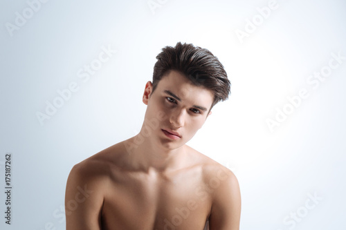 Delighted male person looking straight at camera