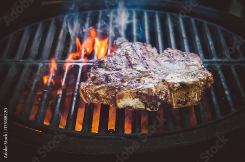 Steak ribi black angus grilled stripes smoke steam charcoal frying photo