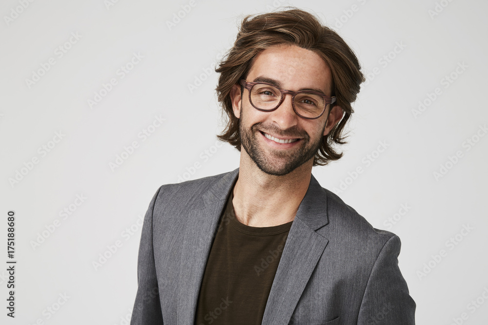 Smiley guy in grey suit jacket and glasses, studio