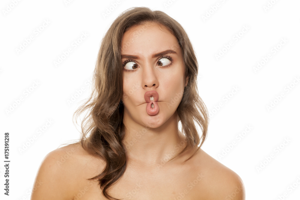 Portrait of beautiful young woman making funny faces on white background Portrait of beautiful young woman making funny faces on white background