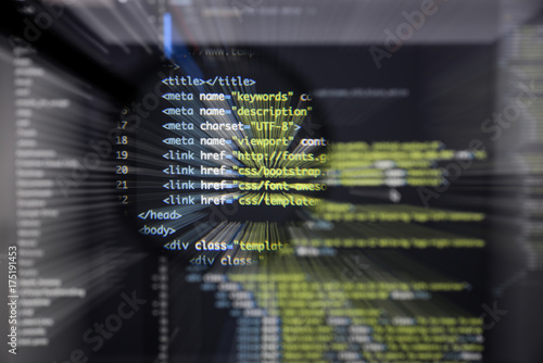 Real Html code developing screen. Programing workflow abstract algorithm concept. Lines of Html code visible under magnifying lens with moviment effect.