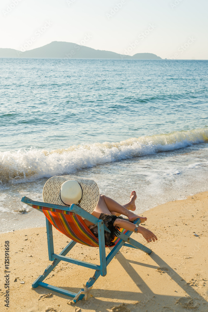 woman relaxing on sun bed sofa lounge chair on holidays woman relaxing on sun bed sofa lounge chair on holidays