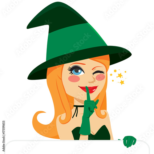Lovely witch with white banner winking and making silence or secret hand gesture with finger on lips