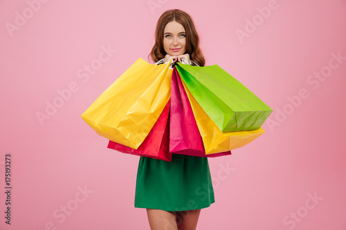 Portrait of a smiling pretty woman in dress looking at camera