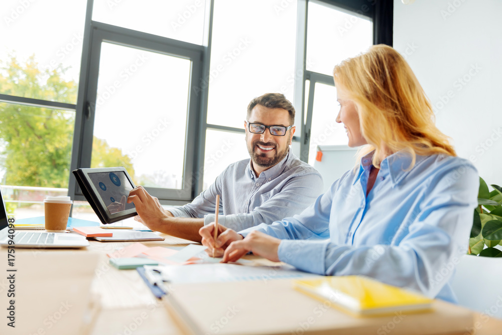 Obraz premium Positive delighted partners working together