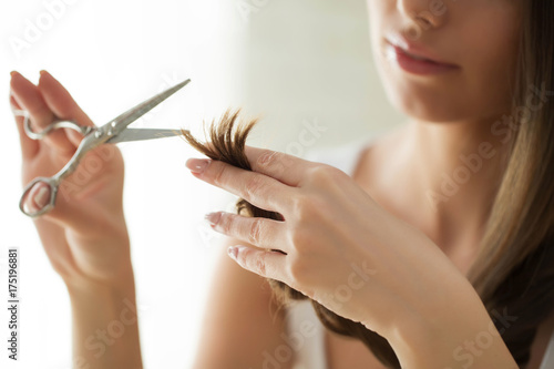 A woman is cutting her hair 