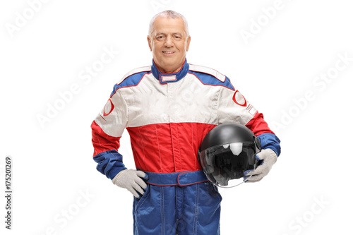 Mature man in a racing suit holding a gray helmet