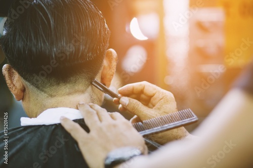 Fotografie person man haircut getting stylish hair vintage shaving, , with razor by barber hairdresser with hands at barbershop