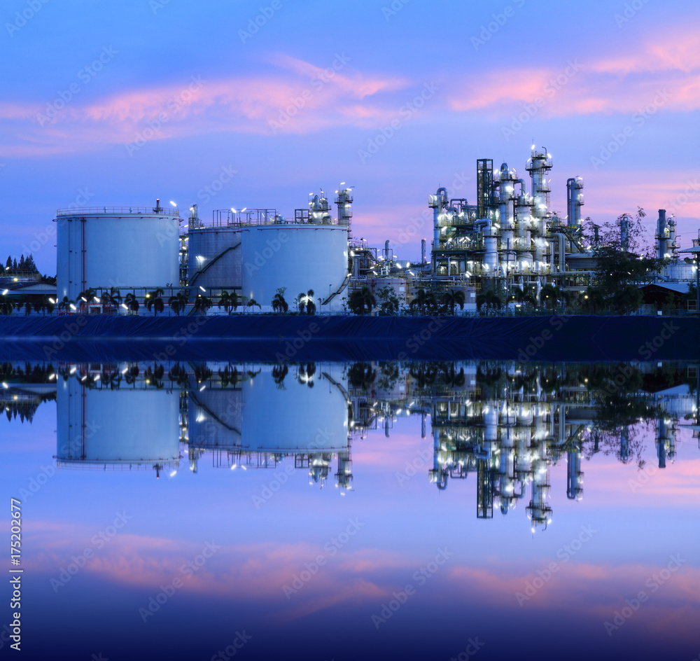 Fototapeta premium Reflection of petrochemical industry on sunset colorful sky