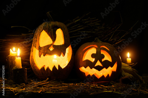 Photo for the holiday Halloween. Two evil pumpkins and a basket with different vegetables and candles