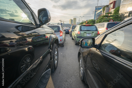 Cars on city street in traffic jam at rush hour