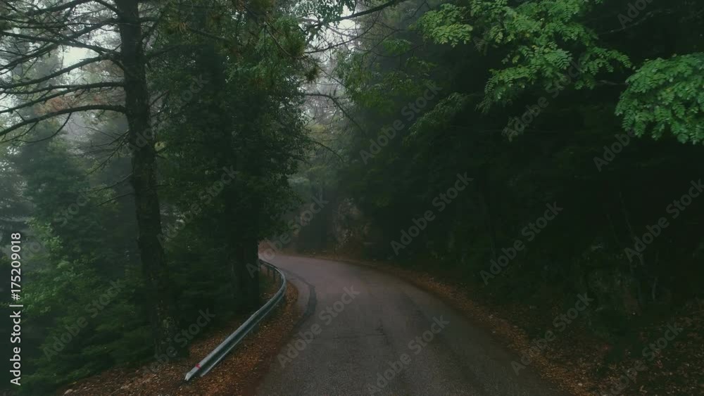 Aerial view of a mountain asphalt road in fog at autumn Aerial view of a mountain asphalt road in fog at autumn