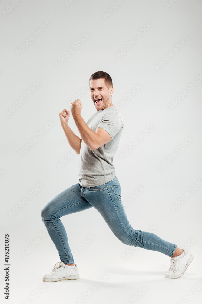 Excited young man make winner gesture. Looking at camera. Excited young man make winner gesture. Looking at camera.