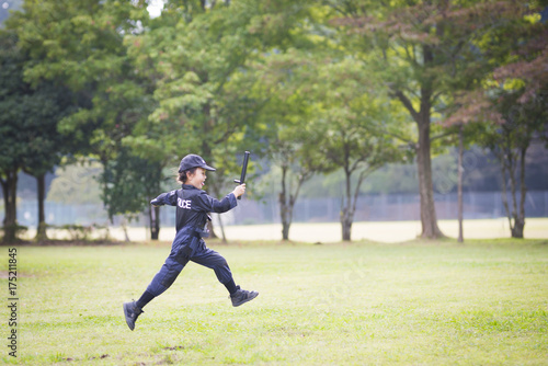 Little girl running in police costume
