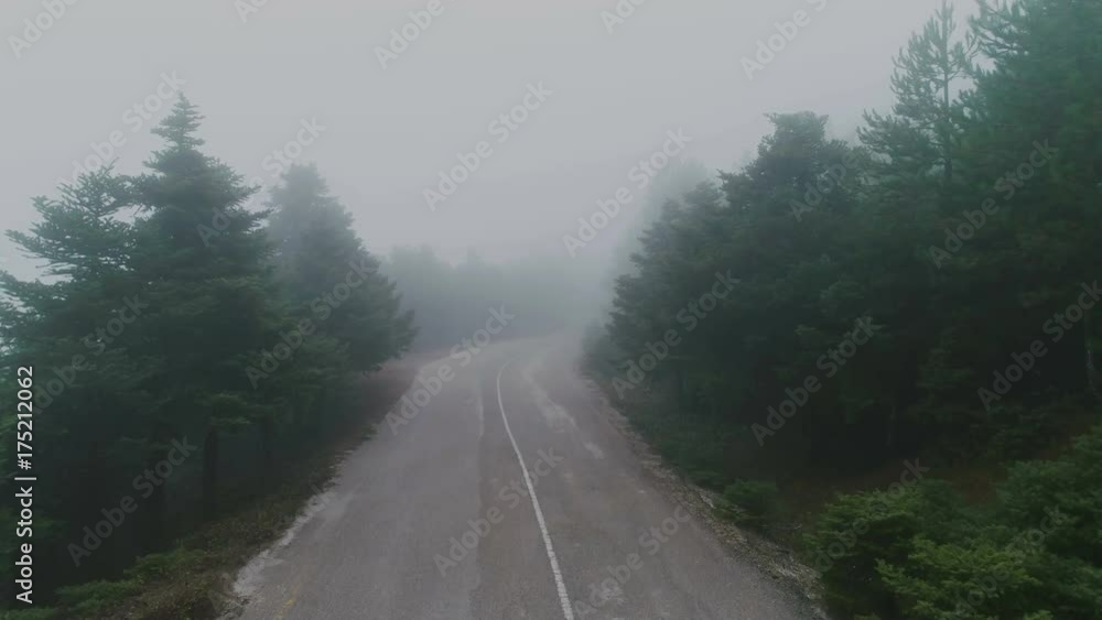 Aerial view of a mountain asphalt road in fog at autumn Aerial view of a mountain asphalt road in fog at autumn
