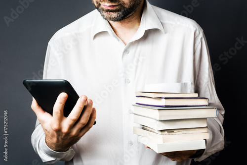 Men with Classic Books and modern electronic EBook Reader, White Shirt,