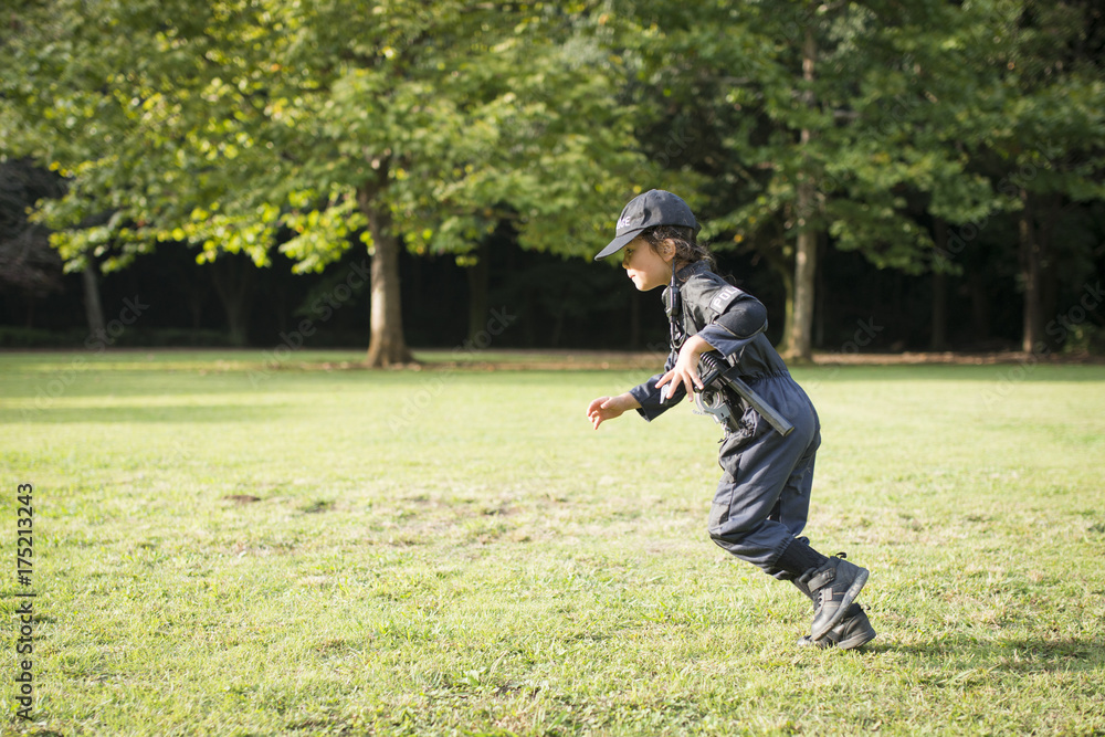 Fototapeta premium Little girl running in police costume