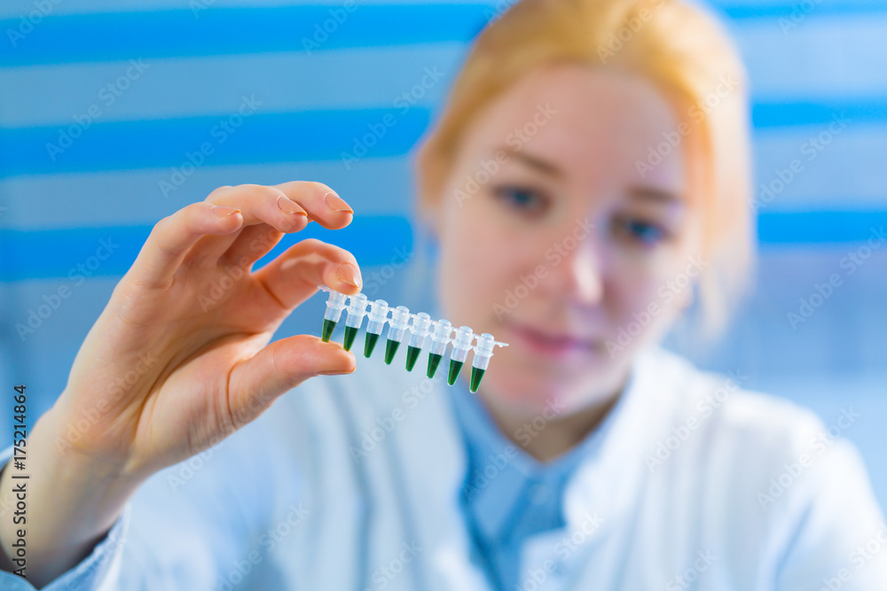 Woman student with pcr devices in medical laboratory Woman student with pcr devices in medical laboratory