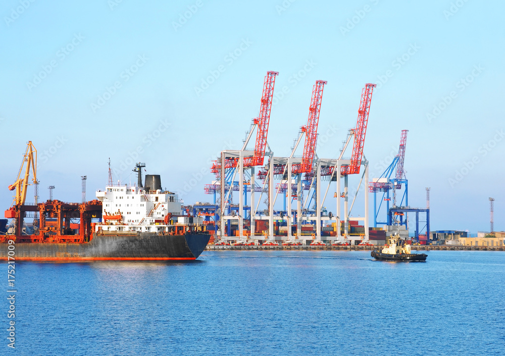 Tugboat assisting container cargo ship