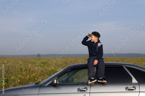 Boy on the roof of the car