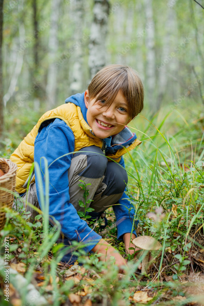 Boy with wild mushroom found in the forest Boy with wild mushroom found in the forest