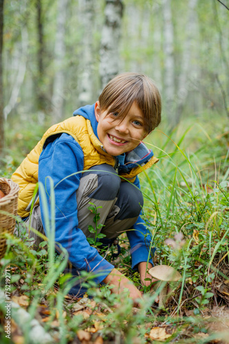 Boy with wild mushroom found in the forest