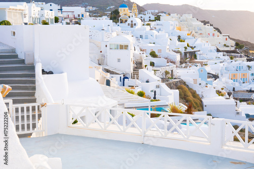Oia town on Santorini island, Greece. Traditional and famous white and rose  houses at sunny day © luchschenF
