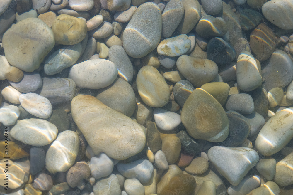 sea pebble beach with multicoloured stones, waves with foam sea pebble beach with multicoloured stones, waves with foam