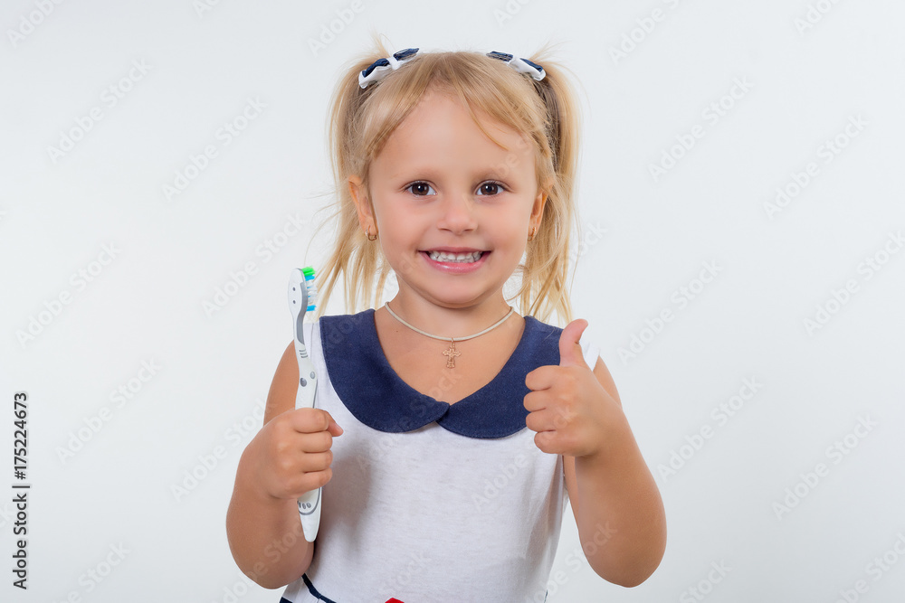 Little girl posing with a toothbrush.. Oral dental health, disease prevention. Positive face expression, emotion Little girl posing with a toothbrush.. Oral dental health, disease prevention. Positive face expression, emotion